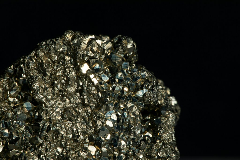 Close up of a shiny mineral block on a black background.